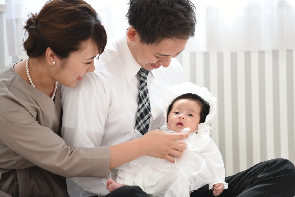 お宮参りの赤ちゃんと、お父さん、お母さん、ベビードレス、健康祈願